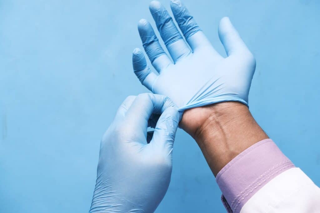 doctor wears medical latex gloves, close up