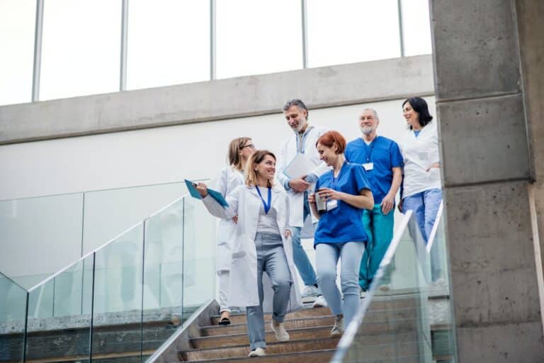 Group of doctors walking down stairs on medical conference